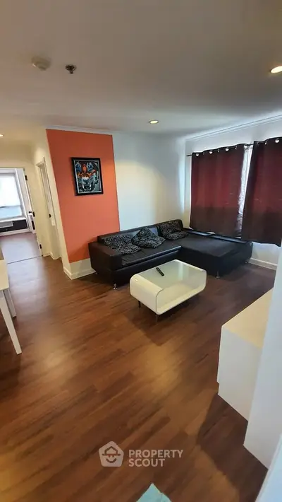 Modern living room with wooden flooring and stylish furniture