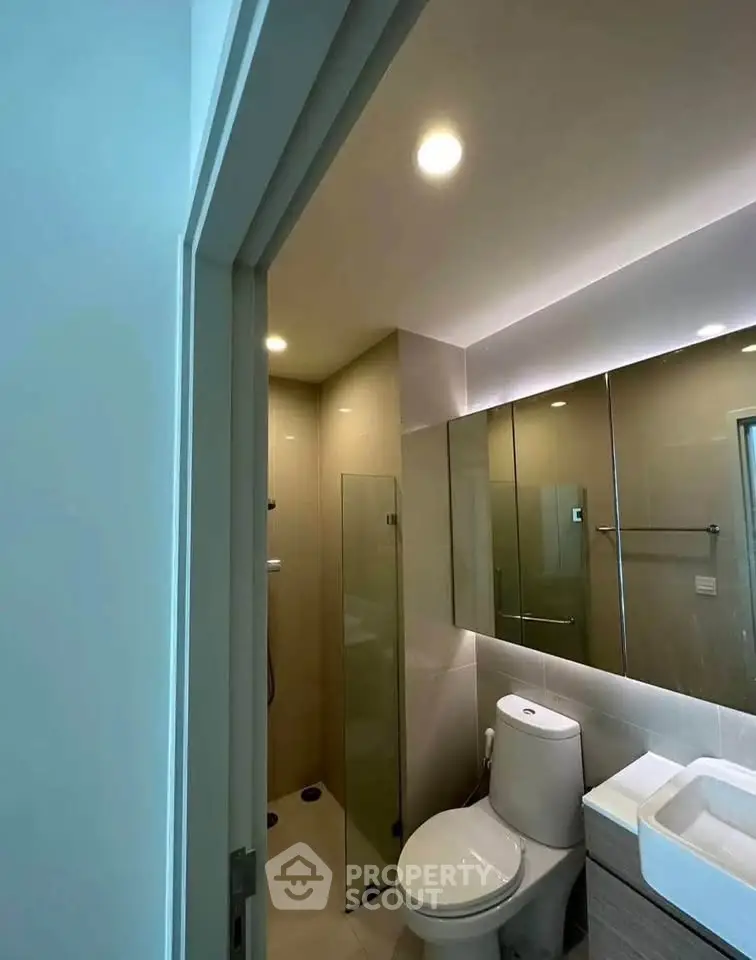 Modern bathroom with sleek fixtures and glass shower enclosure