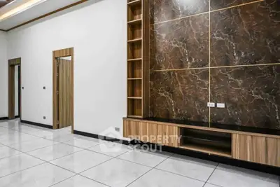 Modern living room with elegant marble wall and built-in wooden shelves