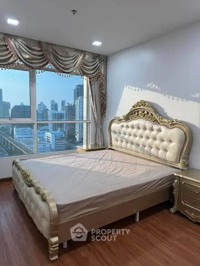 Luxurious bedroom with ornate bed and city view, perfect for elegant living.