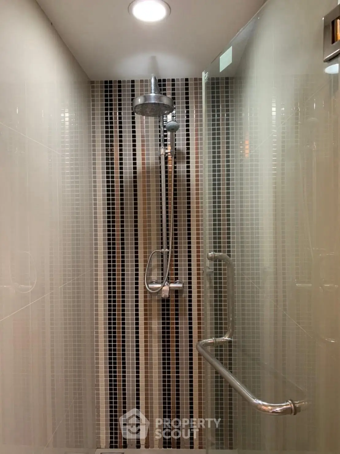 Modern bathroom shower with sleek tile design and chrome fixtures