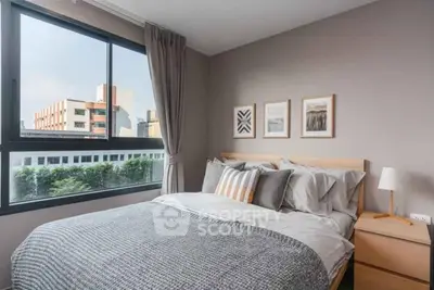 Cozy bedroom with large window and modern decor in urban apartment