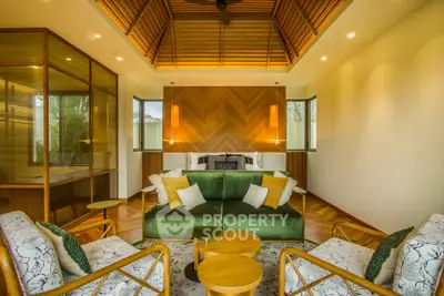 Luxurious living room with vaulted wooden ceiling and elegant decor