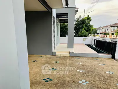 Spacious outdoor patio with tiled flooring in a modern residential area