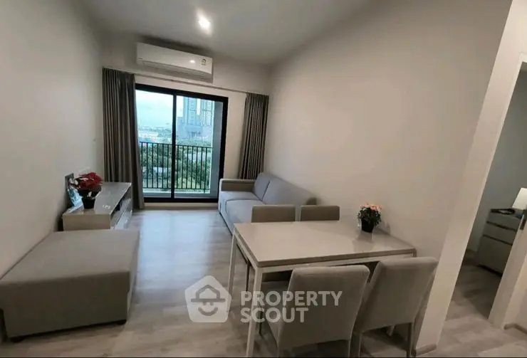 Modern living room with sleek furniture and large windows for natural light.