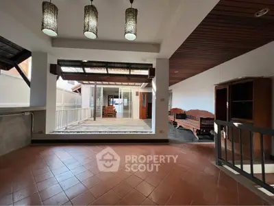 Spacious open-plan living area with elegant wooden accents and ample natural light, perfect for modern living.