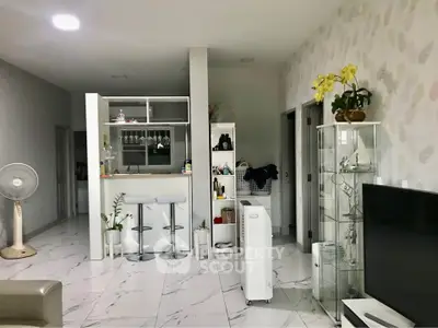 Modern open-layout living room with stylish decor and marble flooring