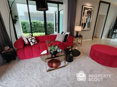 Stylish modern living room with red sofa and elegant decor