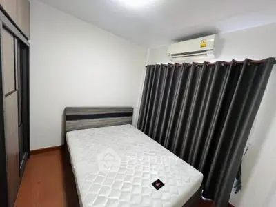 Cozy bedroom with modern air conditioning and stylish curtains, perfect for restful nights.