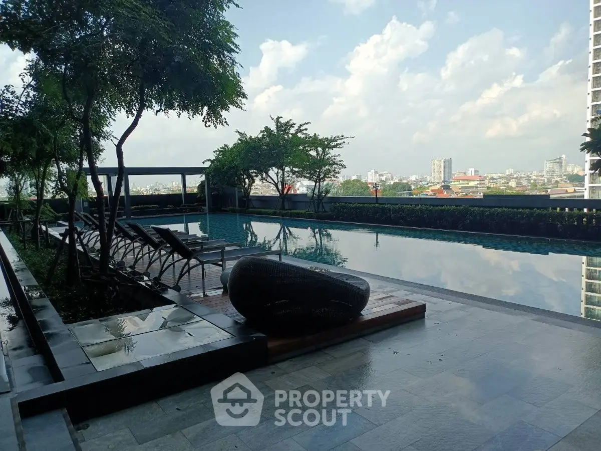 Luxurious rooftop pool with stunning city views and modern lounge chairs.