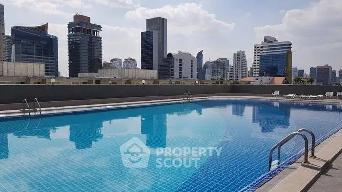 Stunning rooftop pool with city skyline views, perfect for relaxation and leisure in a modern urban setting.