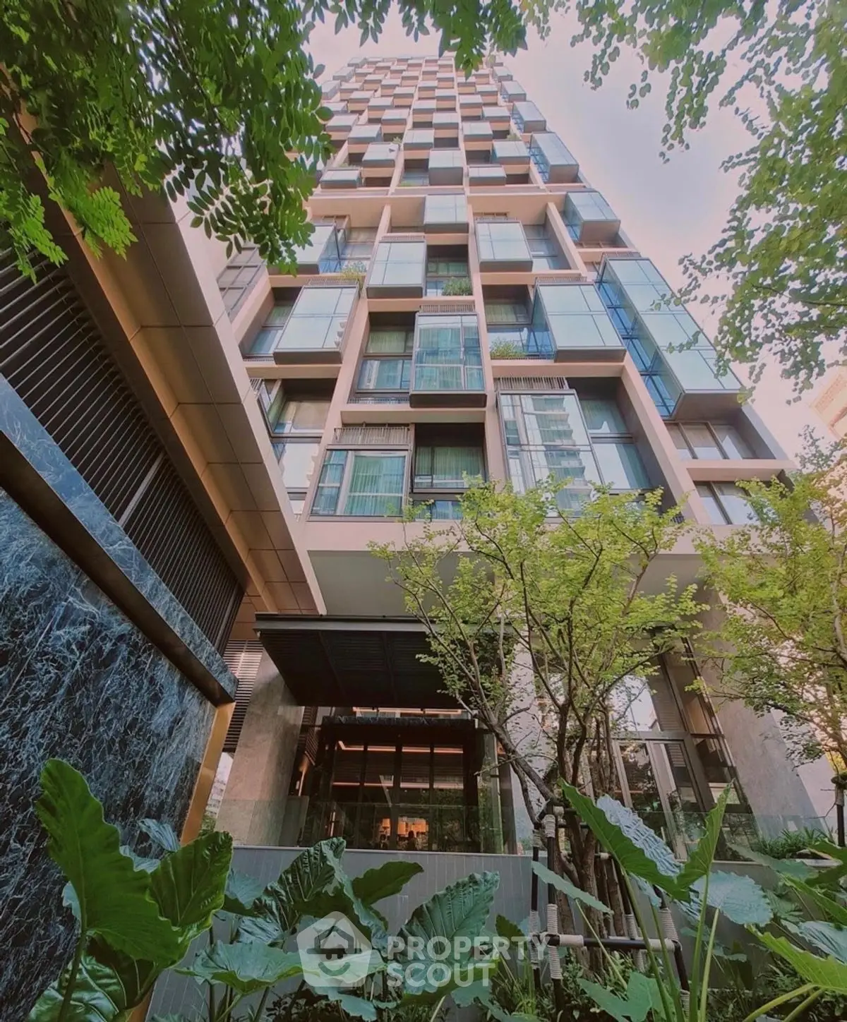 Stunning modern high-rise building with lush greenery and elegant facade