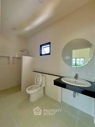 Spacious modern bathroom with sleek fixtures and elegant tile design.