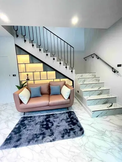 Modern living room with stylish staircase and cozy sofa