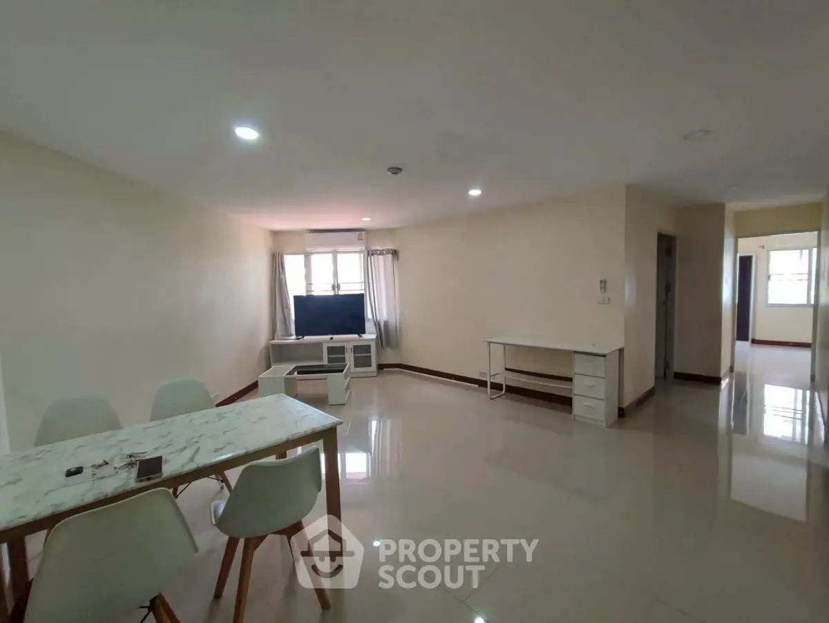Spacious living room with modern dining set and natural light