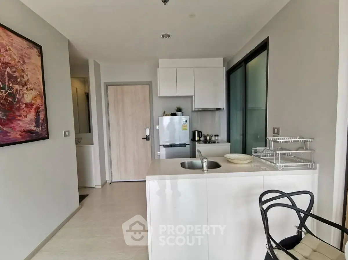 Modern kitchen with sleek design and open layout, featuring a compact island and stylish decor.