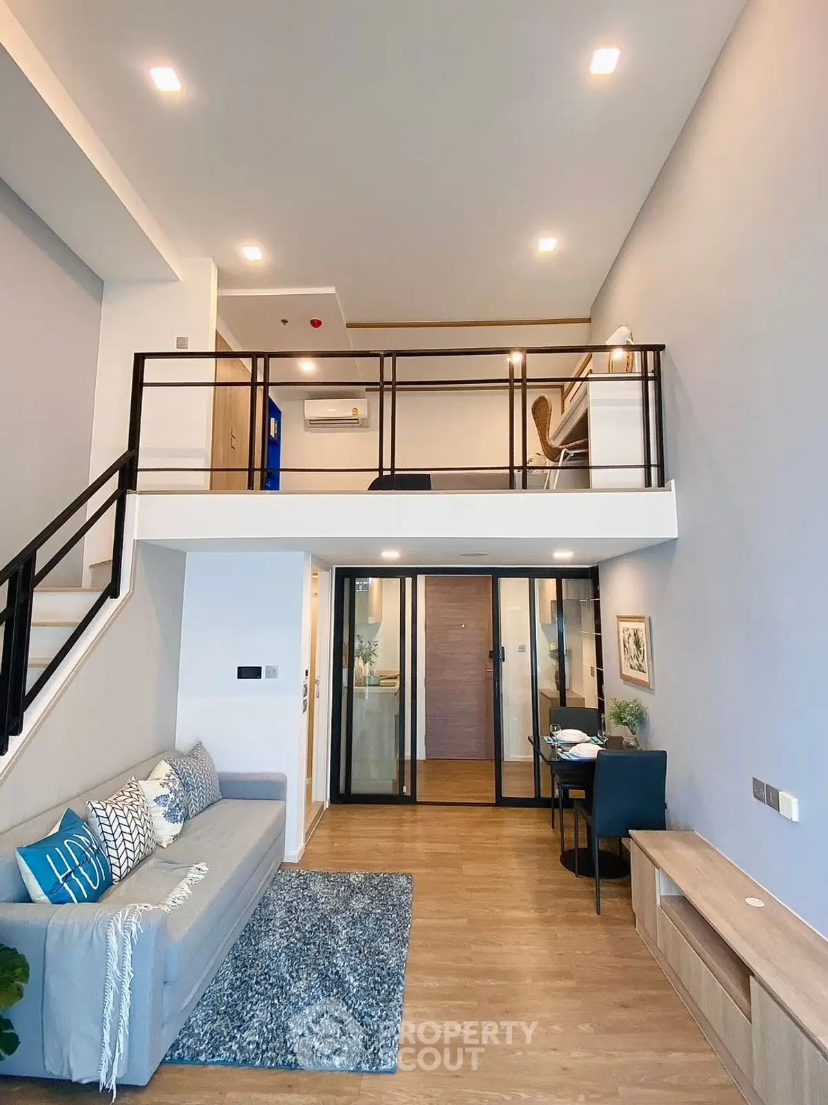 Modern loft-style living room with mezzanine and stylish decor