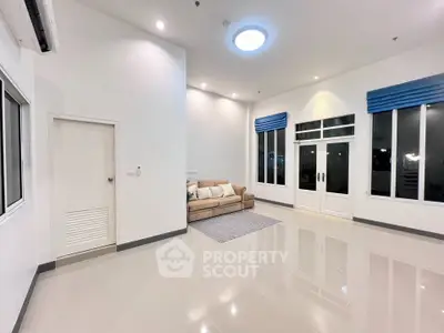 Spacious modern living room with high ceilings and elegant lighting