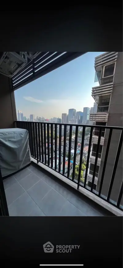 Stunning city view from modern apartment balcony with sleek railing design.
