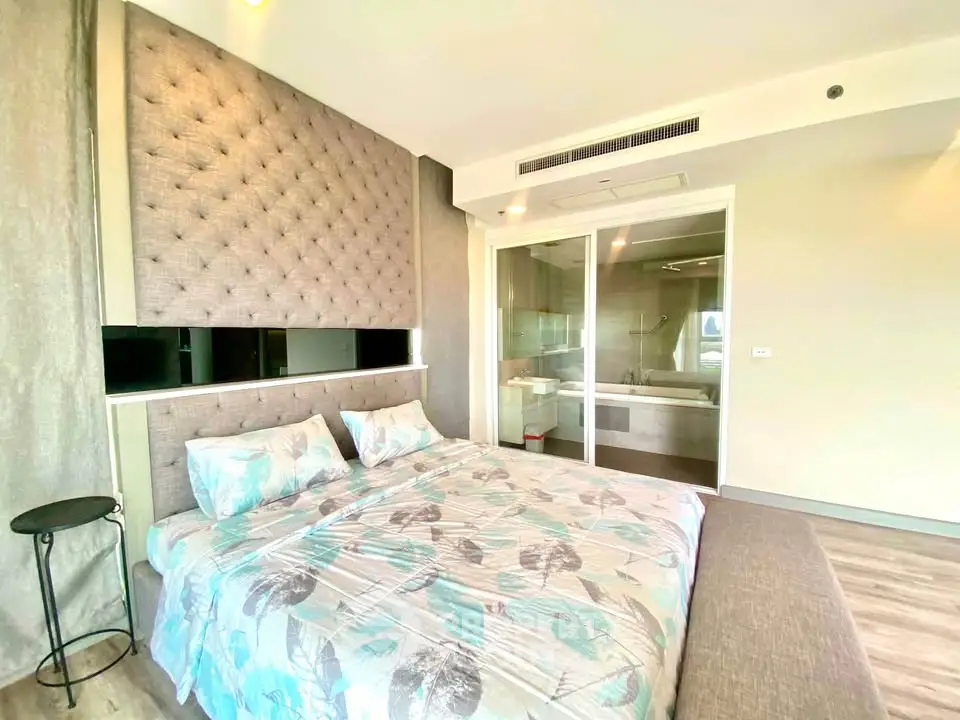 Luxurious bedroom with ensuite bathroom and modern decor in a high-end apartment.