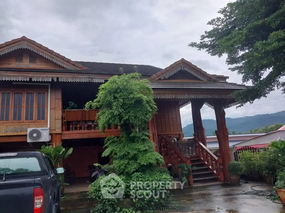 Charming wooden house with lush greenery and mountain views, perfect for serene living.