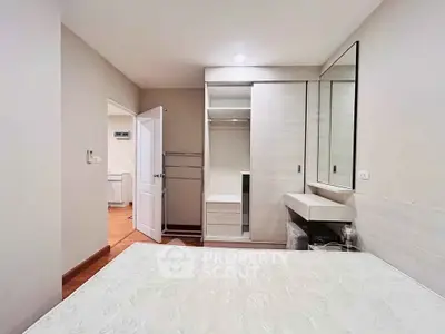 Spacious bedroom with built-in wardrobe and modern decor