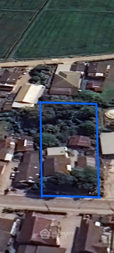 Aerial view of residential area with outlined property boundary