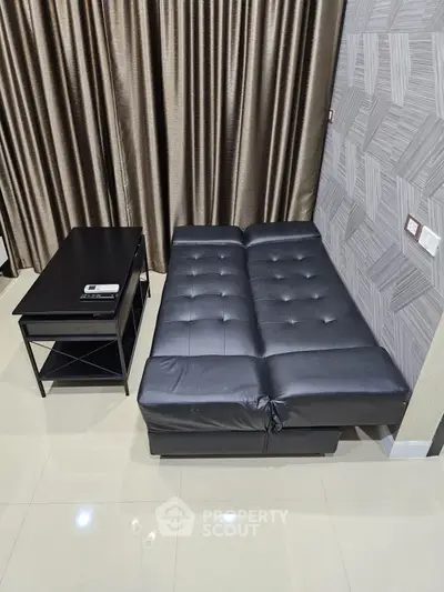 Modern living room with sleek black sofa bed and stylish coffee table