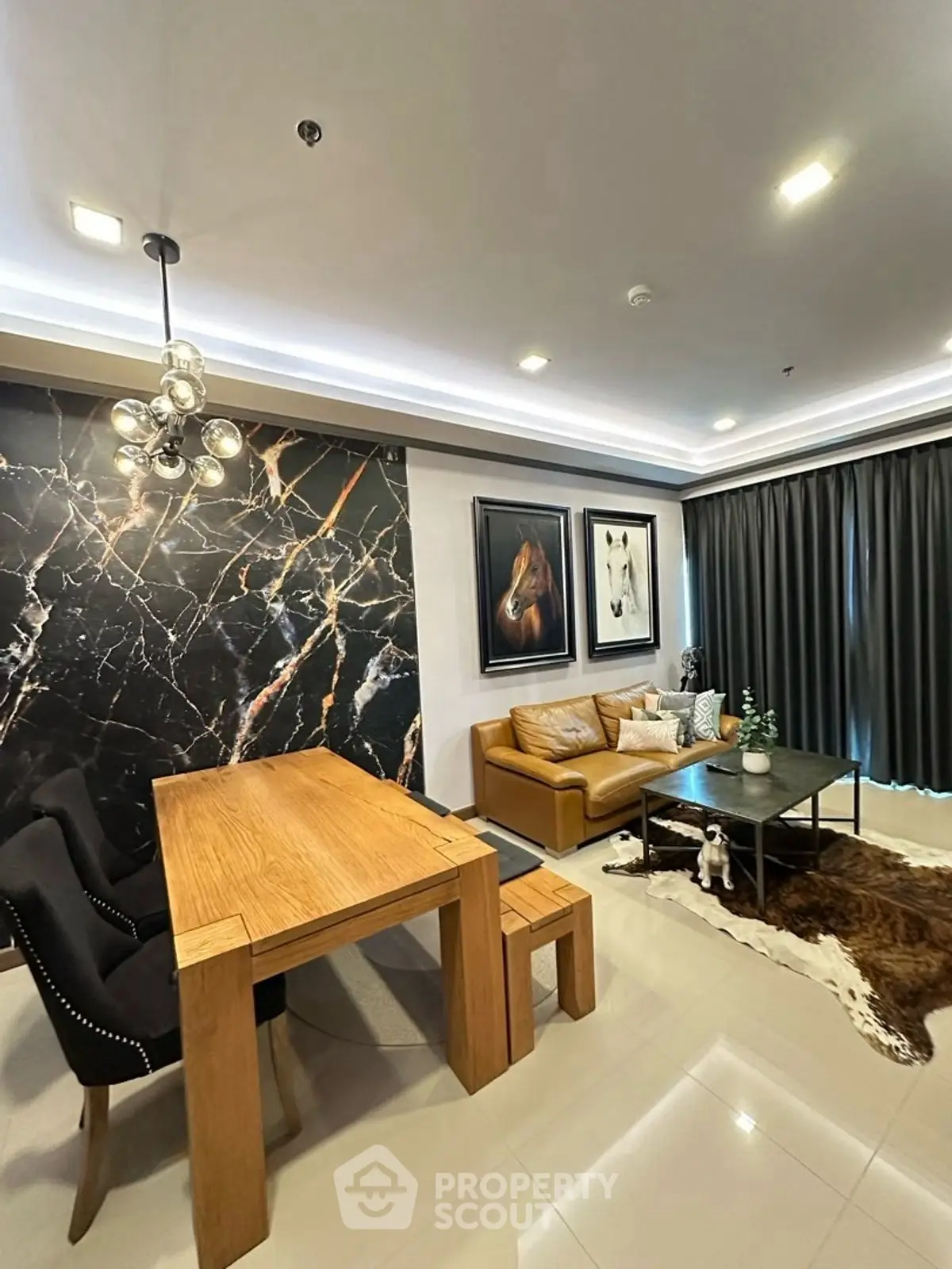 Modern living room with elegant decor, featuring a marble accent wall, stylish furniture, and ambient lighting.
