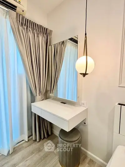 Elegant bedroom corner with modern vanity and stylish lighting