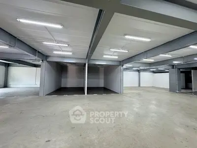 Spacious industrial warehouse with high ceilings and ample storage space.