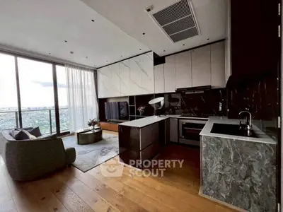Luxurious open-layout living room with modern kitchen and stunning city view.