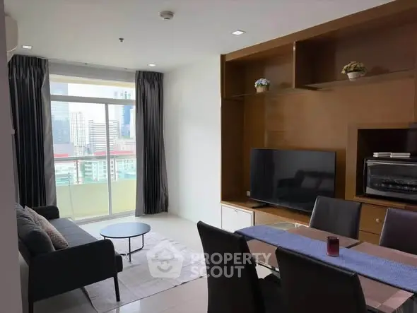 Modern living room with city view, sleek furniture, and entertainment setup.