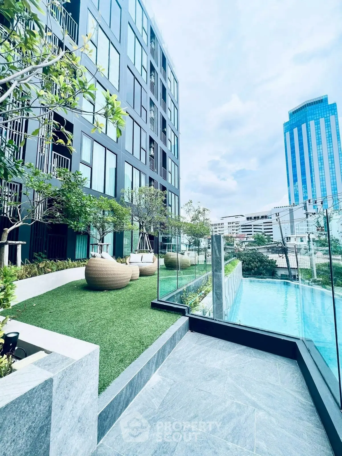 Modern apartment building with pool and garden in urban setting