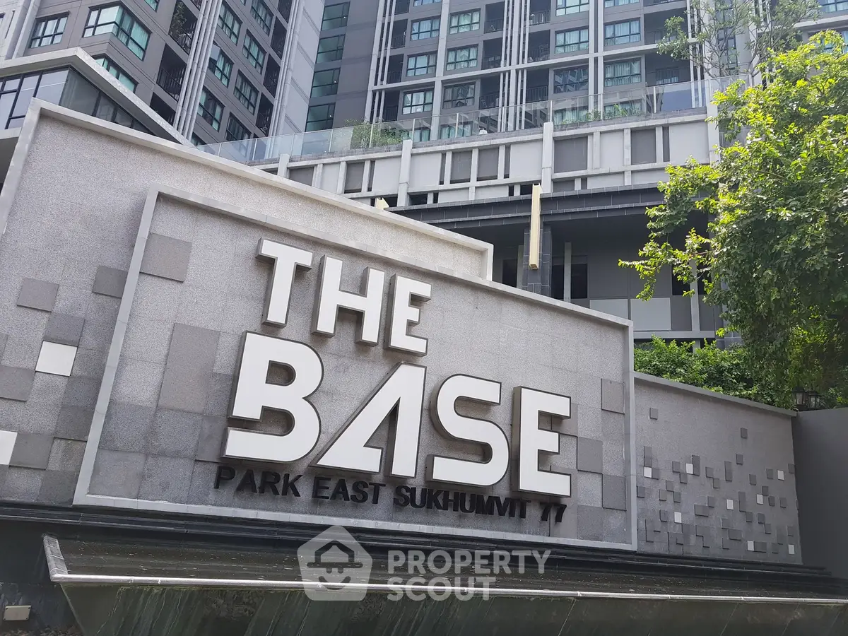 Modern condominium building exterior with prominent signage at The Base Park East Sukhumvit 77.