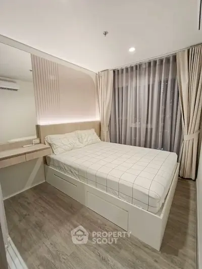 Modern bedroom with stylish decor and large window for natural light