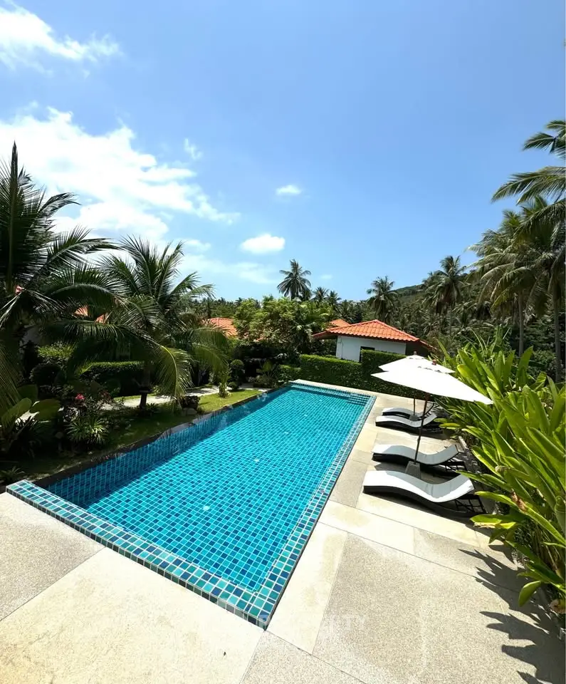 Luxurious tropical villa with private pool and lush garden, perfect for relaxation and leisure.