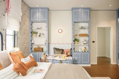 Charming bedroom with built-in shelves and cozy decor, perfect for a child's retreat.