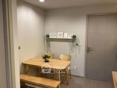 Cozy dining nook with wooden table and chairs, perfect for intimate meals.