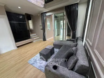 Spacious modern living room with elegant decor and large windows for natural light.