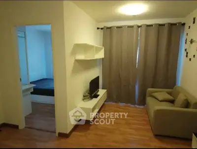 Cozy living room with modern decor and adjacent bedroom view