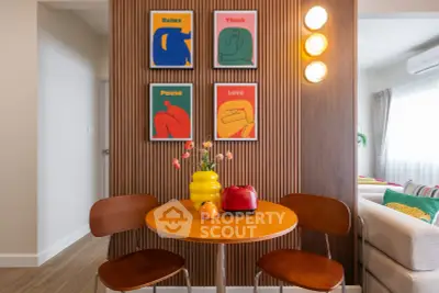 Chic dining nook with vibrant art and modern decor in cozy apartment
