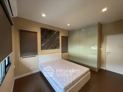 Modern bedroom with sleek design and large wardrobe, perfect for stylish living.