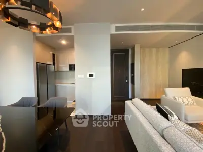 Modern open-plan living room with sleek kitchen and stylish furnishings