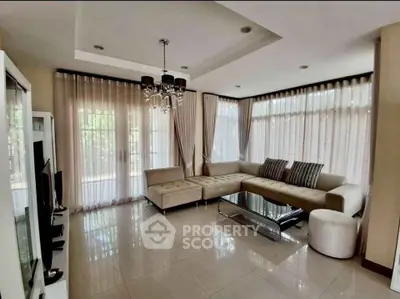 Elegant living room with modern chandelier and large windows