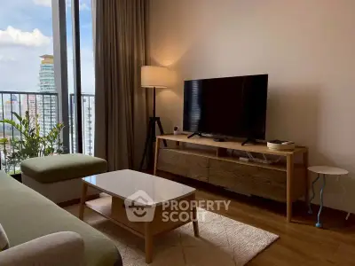 Modern living room with stylish furniture and city view from balcony.