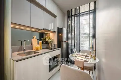 Modern kitchen with sleek cabinetry, stainless steel appliances, and cozy dining area.