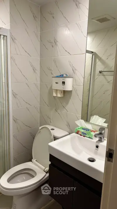 Modern bathroom with sleek fixtures and marble tile design