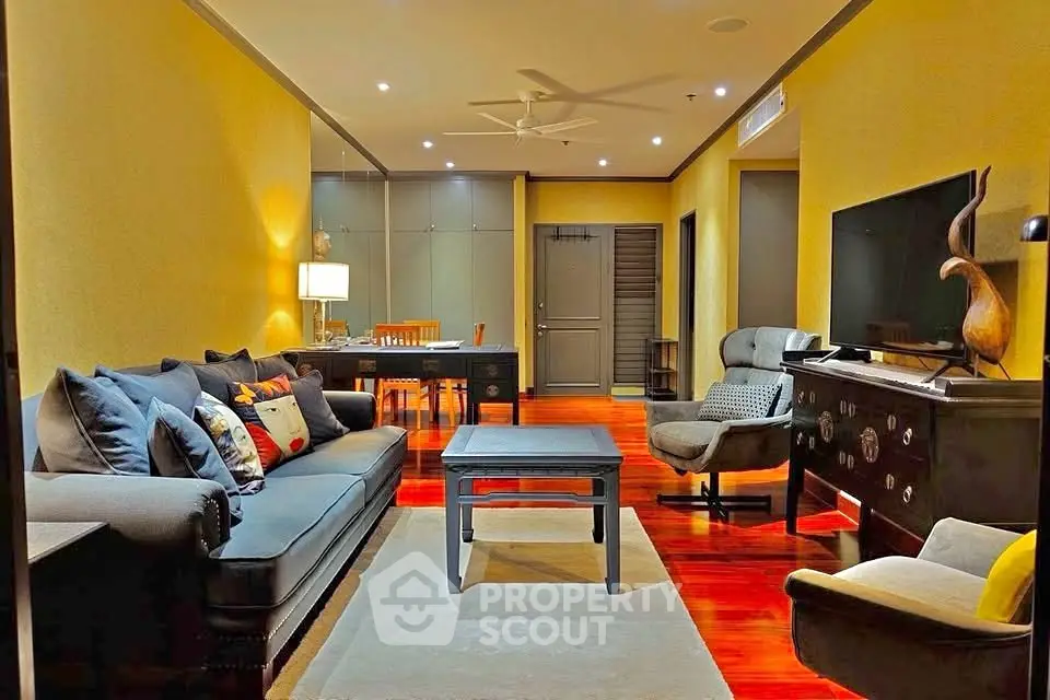 Spacious living room with elegant furniture and warm lighting, perfect for relaxation and entertainment.