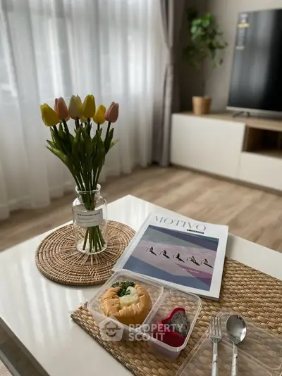 Stylish living room with elegant decor and natural light, featuring a modern coffee table setup.